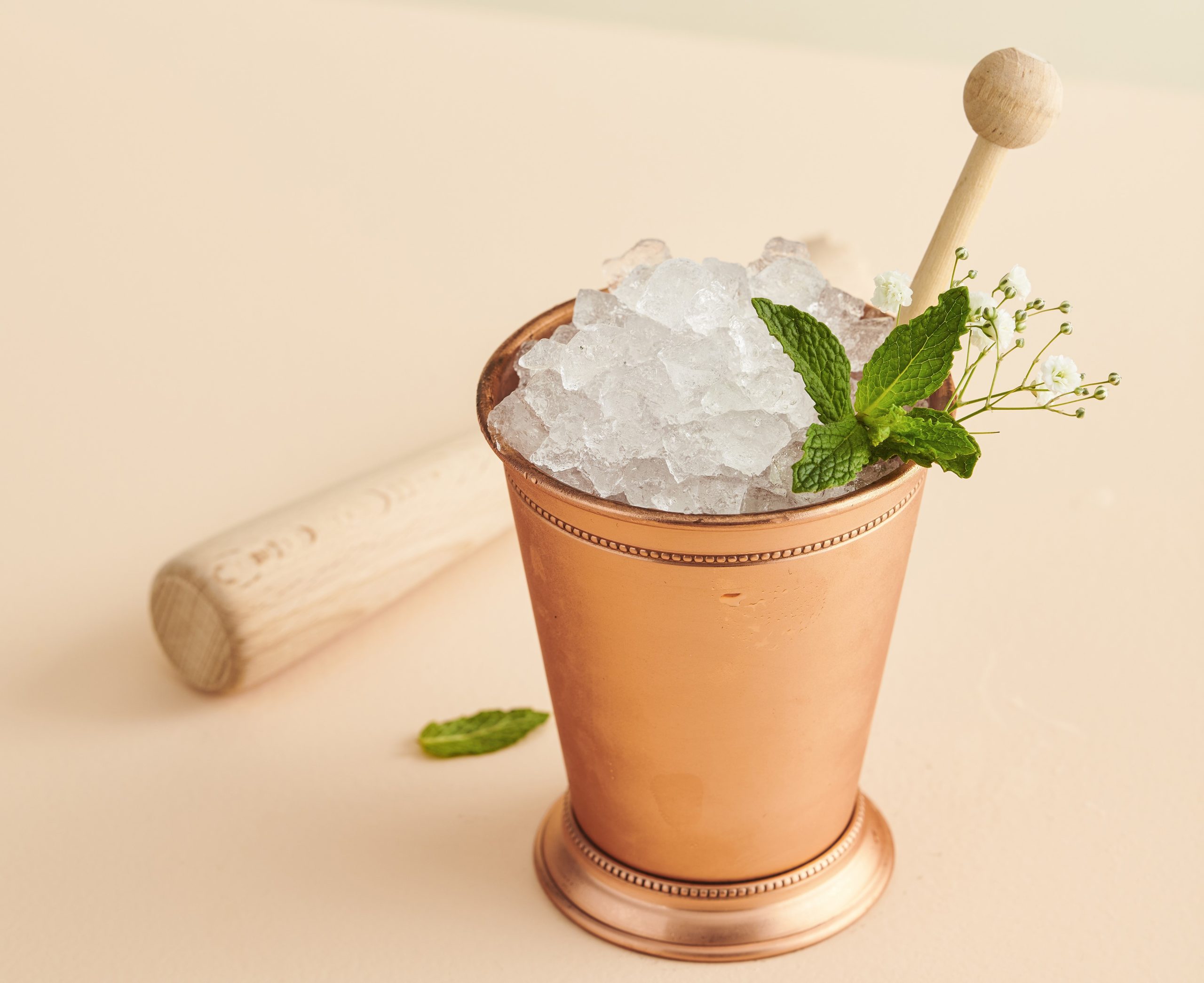 Mint Julep cocktail in a brass julep cup topped with crushed ice and a mint garnish