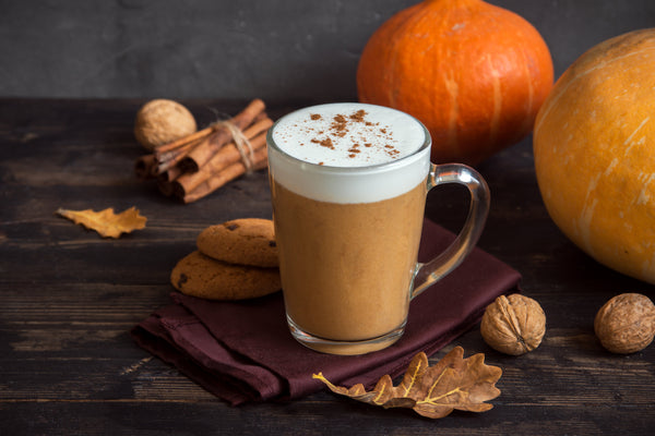 Pumpkin Spice Latte. Cup of Latte with Seasonal Autumn Spices, Cookies and Fall Decor. Traditional Coffee Drink for Autumn Holidays.