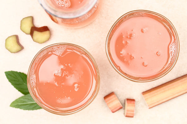 Refreshing homemade rhubarb juice in glasses, photographed overhead (Selective Focus, Focus on the juice)