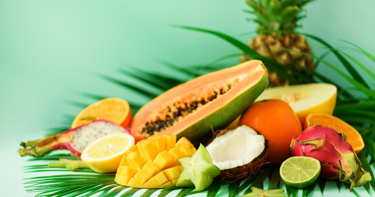 Tropical fruits in front of a green background