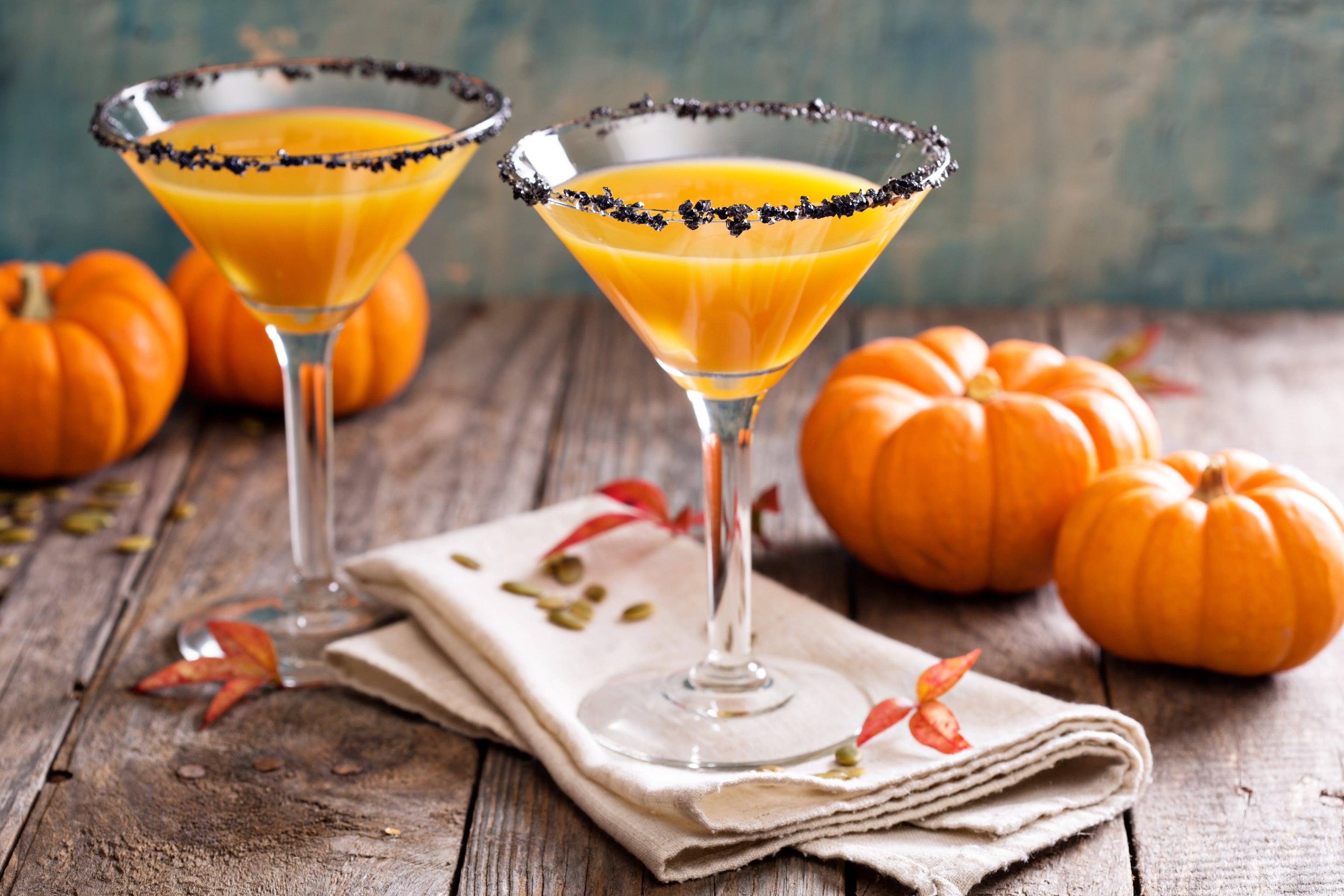 Pumpkintini pumpkin martini coctail with black salt rim for fall and halloween parties