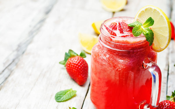 Strawberry lemonade on a white wooden background. toning. selective focus