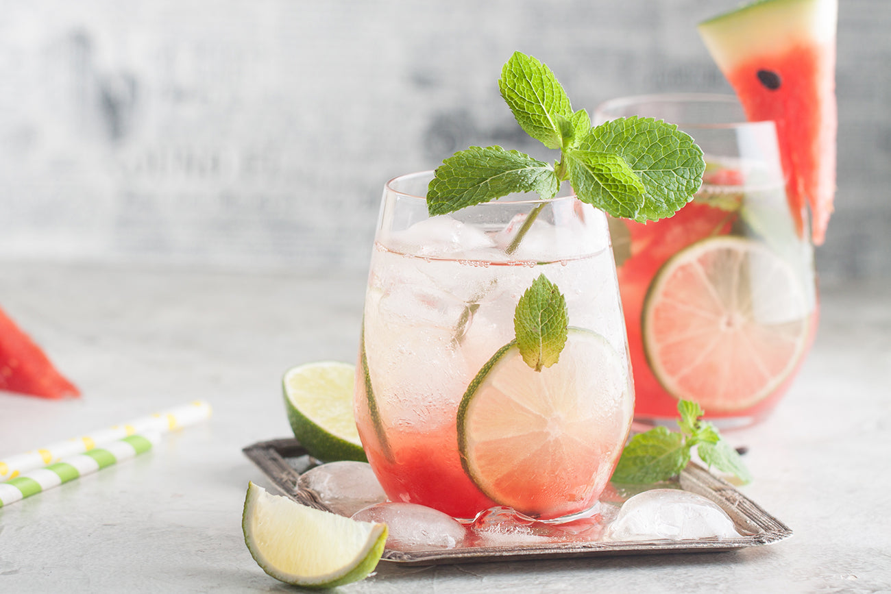 Fresh watermelon lemonade with lime, ice and mint for the summer party on the metal tray